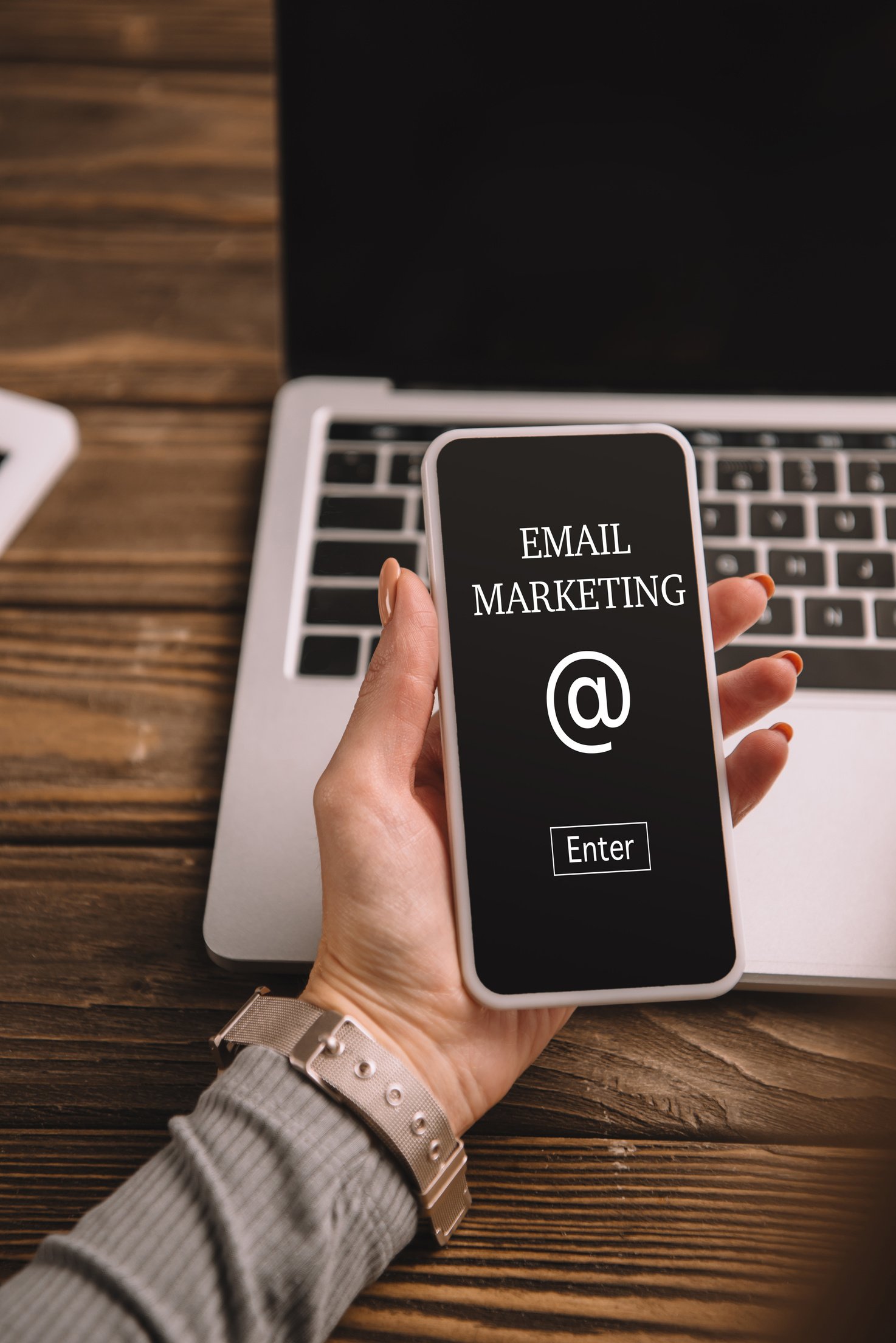 cropped view of businesswoman holding smartphone with email marketing